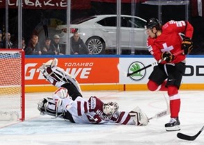 PRAGUE, CZECH REPUBLIC - MAY 6: Latvia's Edgars Maslaskis #31 sprawls out to make the save against Switzerland's Damien Brunner #96 during preliminary round action at the 2015 IIHF Ice Hockey World Championship. (Photo by Andre Ringuette/HHOF-IIHF Images)


