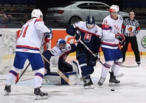 OSTRAVA, CZECH REPUBLIC - MAY 6: Norway's Andreas Martinsen #24 and Slovakia's Juraj Mikus #26 battle for a loose puck in front of Slovakia's Jan Laco #50 during preliminary round action at the 2015 IIHF Ice Hockey World Championship. (Photo by Richard Wolowicz/HHOF-IIHF Images)

