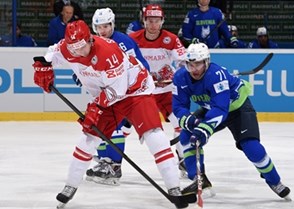 OSTRAVA, CZECH REPUBLIC - MAY 11: Denmark's Kirill Starkov #14 battles for the puck with Slovenia's Bostjan Golicic #71 during preliminary round action at the 2015 IIHF Ice Hockey World Championship. (Photo by Richard Wolowicz/HHOF-IIHF Images)

